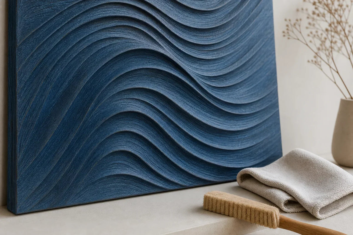 Soft cloth and natural brush beside blue carved wood wall art for gentle dry care