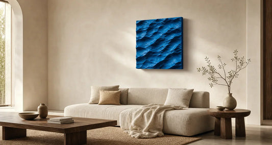 Handmade blue wave wall art above a calm neutral living room sofa